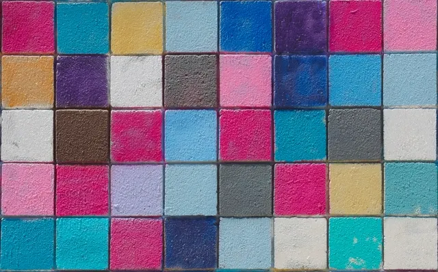 Painted mosaic tile wall in pink, blue, and teal